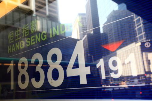 hang seng index on board with building reflect on it